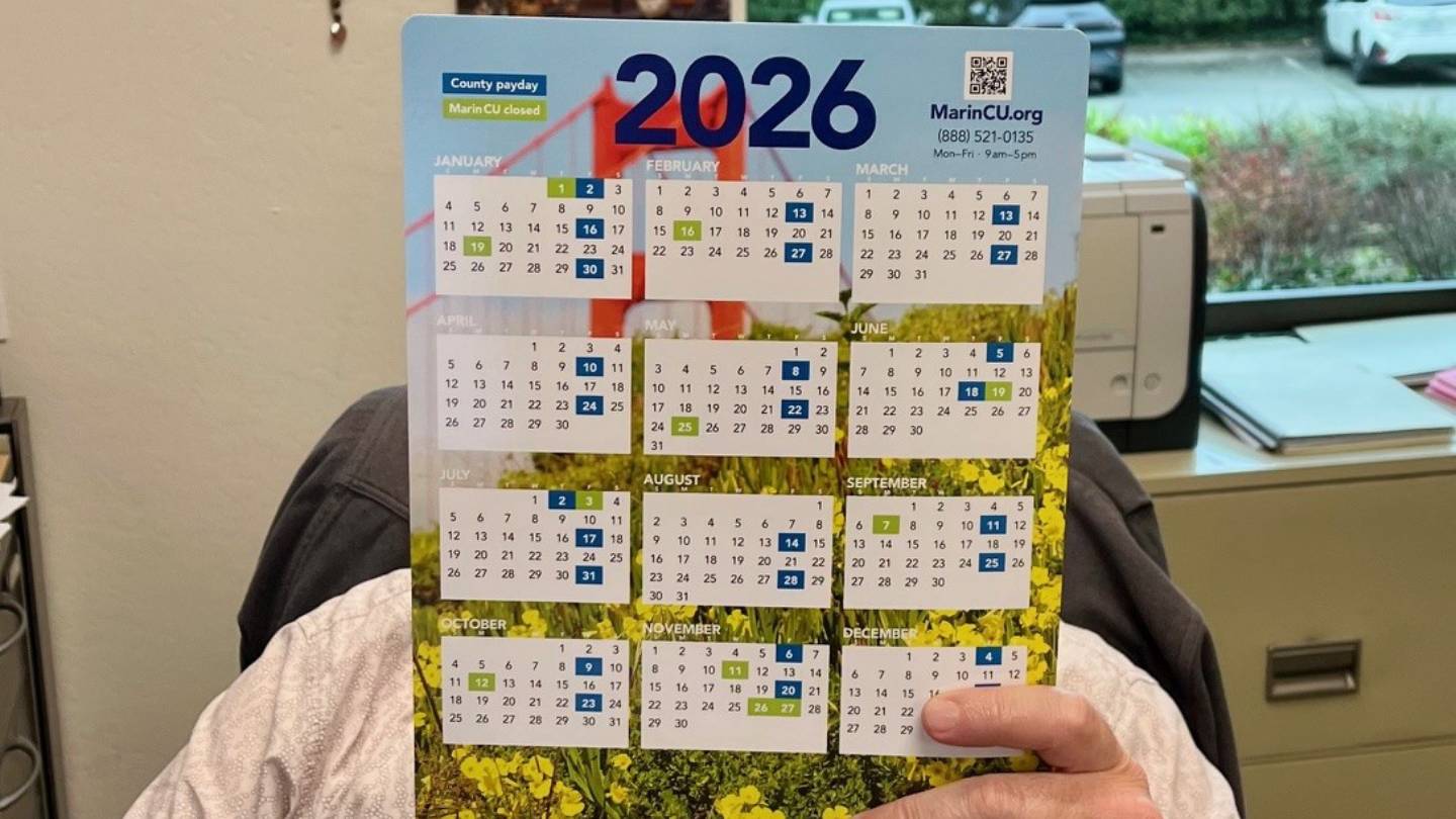Person holding 2026 wall calendar