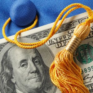 Image of a $100 American bill and a graduation cap with tassel.